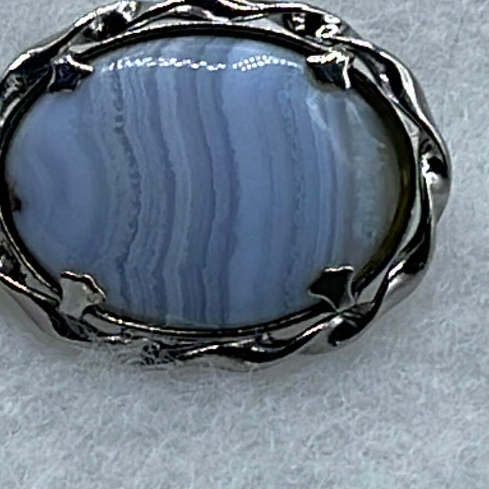 Vintage blue lace agate gemstone in a silvertone oval frame.